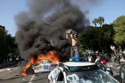 Waymo vehicles set on fire in downtown L.A. as protesters, police clash